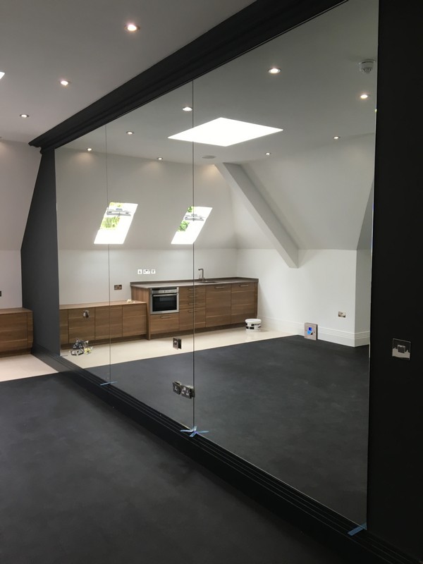 Frameless glass partition in loft conversion by Elephant & Castle glaziers